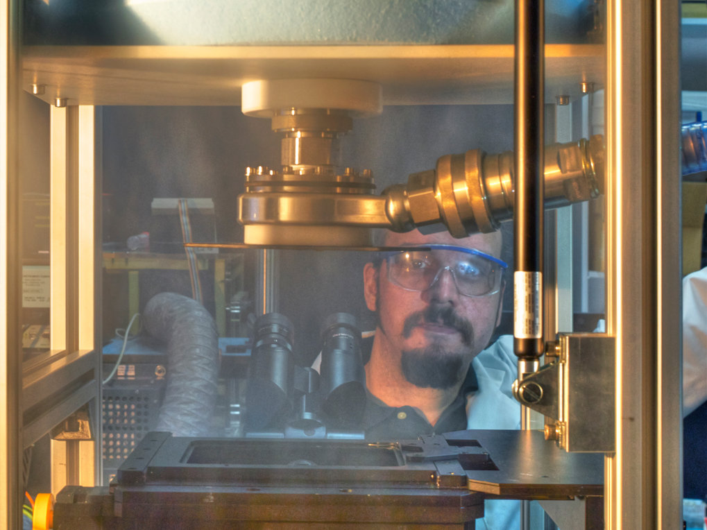 Ultra-rapid cryo-arrest microscope with person behind the device.